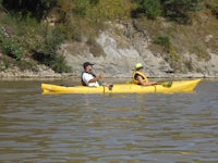 two people in a yellow canoe