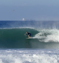 a person riding a wave on a surfboard