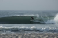 a person riding a wave on a surfboard