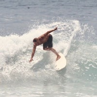 a surfer riding a wave on a surfboard